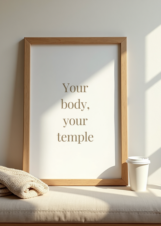 Framed quote 'Your body, your temple' on a wall with a blanket and cup below.